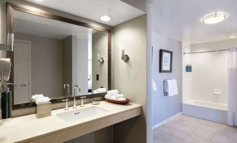 Guest bathroom with shower and tub at Hilton San Francisco Financial District.