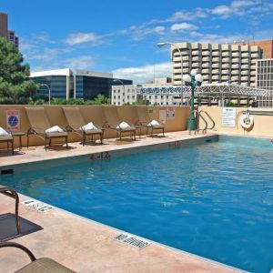 Refreshing outdoor pool surrounded by sunbeds at DoubleTree By Hilton Albuquerque.