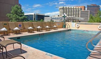 Refreshing outdoor pool surrounded by sunbeds at DoubleTree By Hilton Albuquerque.