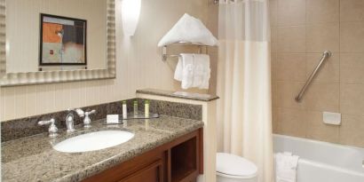 Guest bathroom with shower and tub at DoubleTree By Hilton Albuquerque.