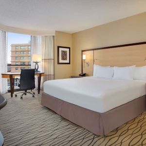 Spacious king room with TV and work area ideal for working remotely at Hilton Rosemont/Chicago O'Hare.