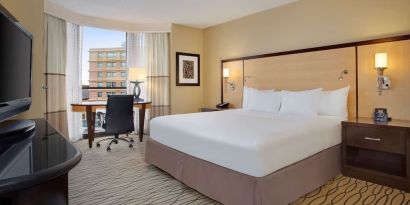 Spacious king room with TV and work area ideal for working remotely at Hilton Rosemont/Chicago O'Hare.