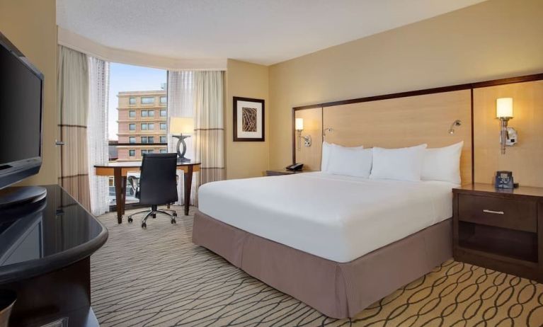 Spacious king room with TV and work area ideal for working remotely at Hilton Rosemont/Chicago O'Hare.