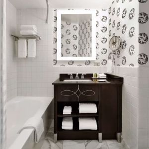 Guest bathroom with shower and tub at Palmer House A Hilton Hotel.