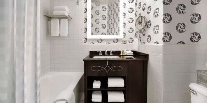 Guest bathroom with shower and tub at Palmer House A Hilton Hotel.