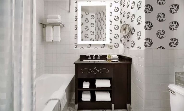 Guest bathroom with shower and tub at Palmer House A Hilton Hotel.
