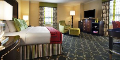 Spacious king suite with work desk and lounger at Palmer House A Hilton Hotel.