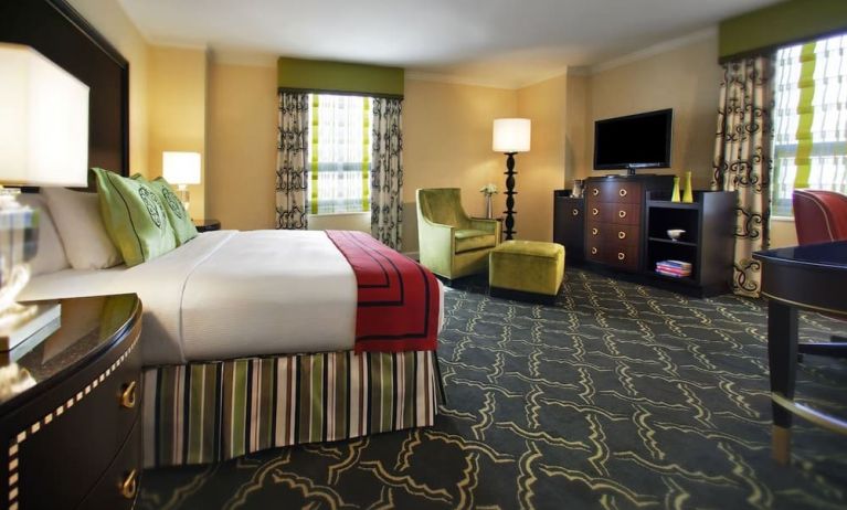 Spacious king suite with work desk and lounger at Palmer House A Hilton Hotel.