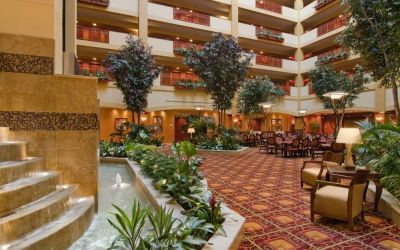 Spacious lobby and coworking lounge with natural light at Embassy Suites By Hilton Hampton Convention Center.