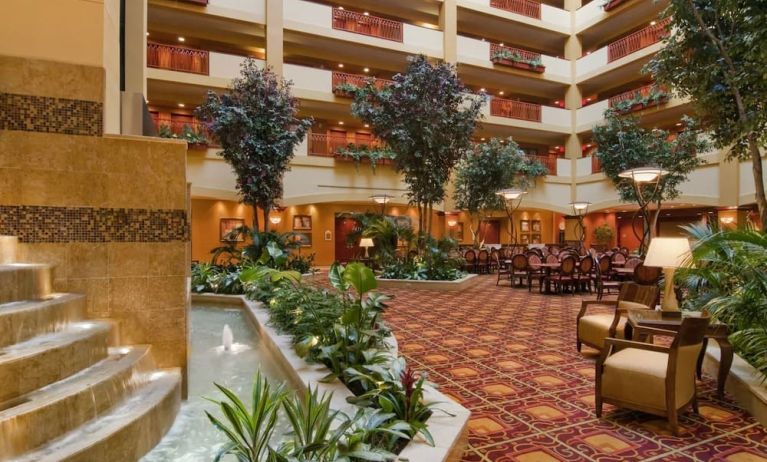 Spacious lobby and coworking lounge with natural light at Embassy Suites By Hilton Hampton Convention Center.