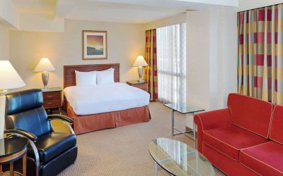 King size suite with sound proofed windows and lounger at Hilton Chicago O'Hare Airport.