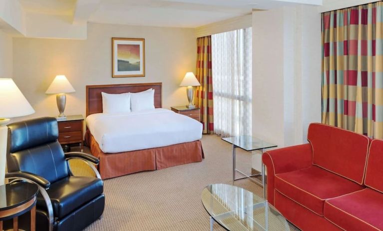 King size suite with sound proofed windows and lounger at Hilton Chicago O'Hare Airport.