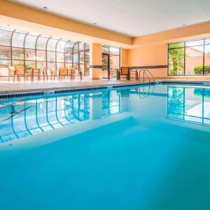 Indoor pool with lounge chairs at Sonesta Select Boston Milford.
