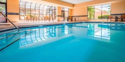 Indoor pool with lounge chairs at Sonesta Select Boston Milford.