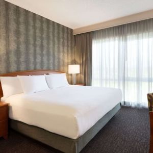 King suite with working station and natural light at Embassy Suites By Hilton Nashville South Cool Springs.