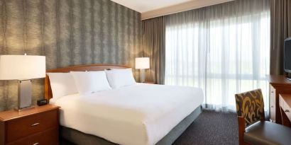 King suite with working station and natural light at Embassy Suites By Hilton Nashville South Cool Springs.
