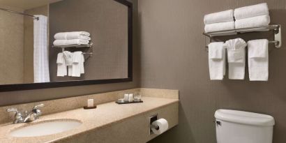 Guest bathroom with shower at Embassy Suites By Hilton Nashville South Cool Springs.