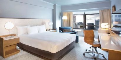 Day use room with work desk and natural light at New York Hilton Midtown.