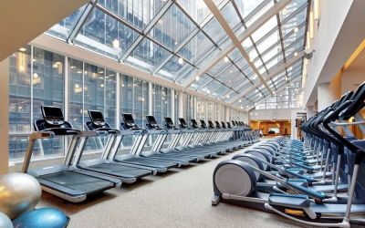 Well-equipped fitness center with natural light at New York Hilton Midtown.