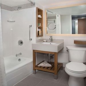 Guest bathroom with shower and tub at New York Hilton Midtown.