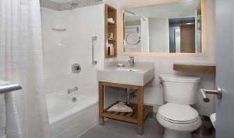 Guest bathroom with shower and tub at New York Hilton Midtown.
