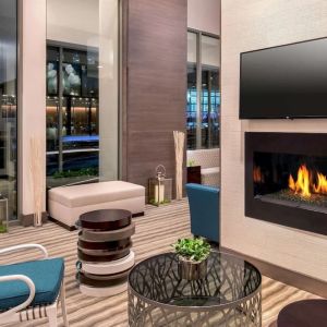 Comfortable lobby workspace by the fireplace at Hilton Garden Inn NYC Financial Center/Manhattan Downtown.
