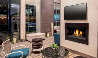 Comfortable lobby workspace by the fireplace at Hilton Garden Inn NYC Financial Center/Manhattan Downtown.
