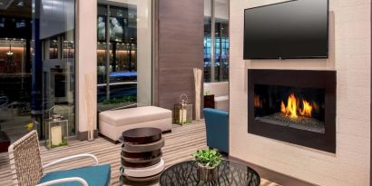 Comfortable lobby workspace by the fireplace at Hilton Garden Inn NYC Financial Center/Manhattan Downtown.
