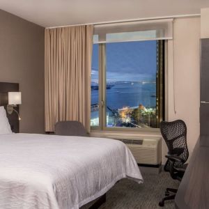 King bedroom with work station and city view at Hilton Garden Inn NYC Financial Center/Manhattan Downtown.

