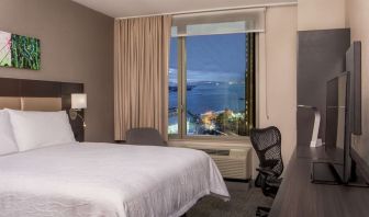 King bedroom with work station and city view at Hilton Garden Inn NYC Financial Center/Manhattan Downtown.
