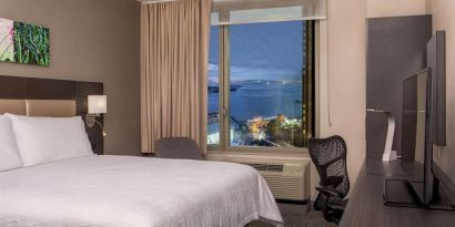 King bedroom with work station and city view at Hilton Garden Inn NYC Financial Center/Manhattan Downtown.
