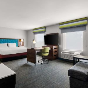 Spacious hotel suite with king size bed and working station at Hampton Inn & Suites Schererville.