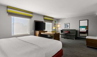 Spacious hotel suite with king size bed and working station at Hampton Inn & Suites Schererville.