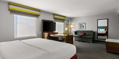 Spacious hotel suite with king size bed and working station at Hampton Inn & Suites Schererville.