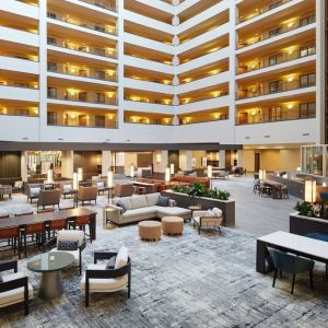 Spacious lobby and coworking lounge at Hilton Charlotte Airport.
