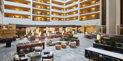 Spacious lobby and coworking lounge at Hilton Charlotte Airport.
