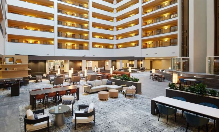 Spacious lobby and coworking lounge at Hilton Charlotte Airport.
