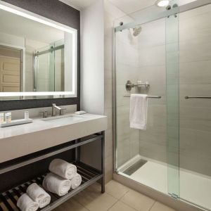 Guest bathroom with shower at Hilton Charlotte Airport.
