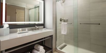 Guest bathroom with shower at Hilton Charlotte Airport.
