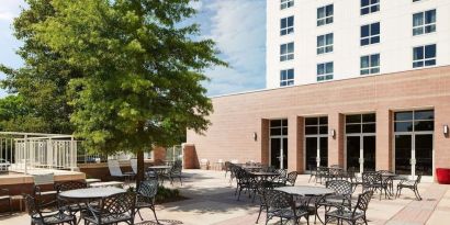Outdoor seats available in the courtyard of the Hilton Charlotte Airport.
