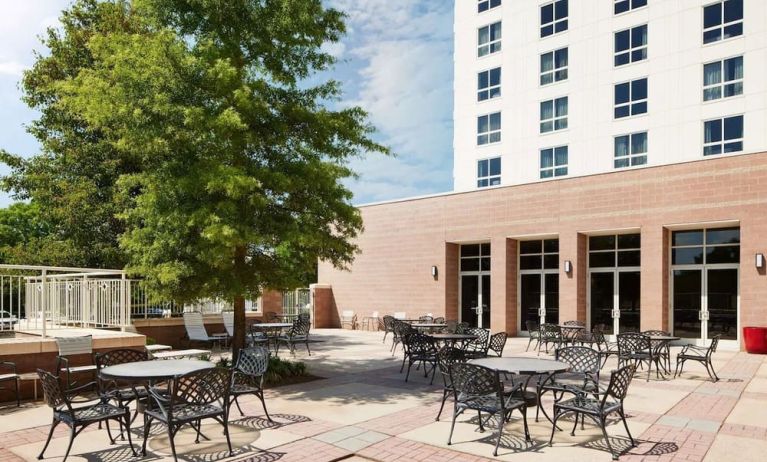 Outdoor seats available in the courtyard of the Hilton Charlotte Airport.
