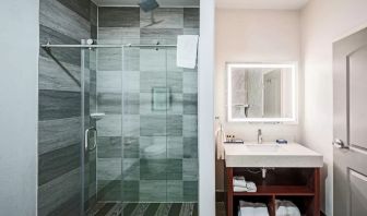 Guest bathroom with shower at The Leo Collection, An Ascend Collection Hotel.