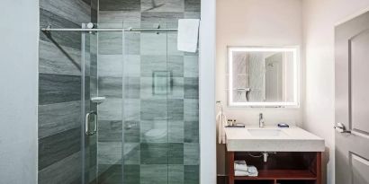 Guest bathroom with shower at The Leo Collection, An Ascend Collection Hotel.