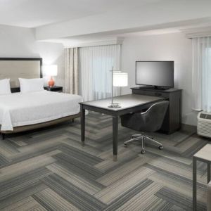 King bed with work desk and living area at Hampton Inn & Suites By Hilton Atlanta Perimeter Dunwoody.