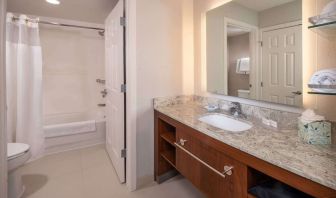 Private guest bathroom with combined shower and tub at Sonesta ES Suites Baltimore BWI Airport.