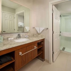 Private guest bathroom with shower and free toiletries at Sonesta ES Suites Baltimore BWI Airport.