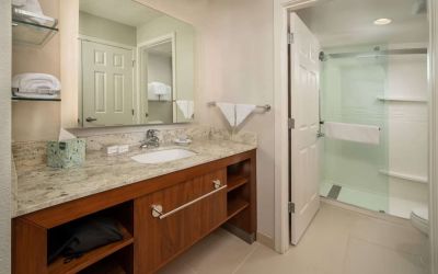 Private guest bathroom with shower and free toiletries at Sonesta ES Suites Baltimore BWI Airport.