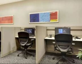 Business center with computers, printer and ergonomic chairs at New York Hilton Midtown.