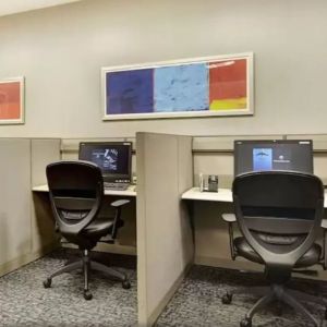 Business center with computers, printer and ergonomic chairs at New York Hilton Midtown.