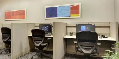 Business center with computers, printer and ergonomic chairs at New York Hilton Midtown.